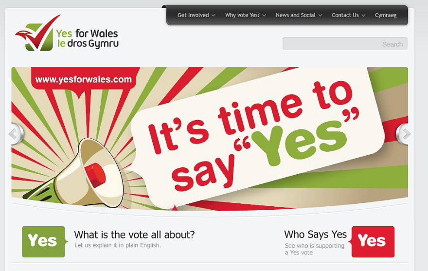 This is a screenshot from a website set up by Yes for Wales. The banner image shows a cartoon megaphone with a speech bubble: 'It's time to say "Yes"'. Underneath the banner there are buttons linking to other sections of the website, labelled with the text: 'What is the vote all about? Let us explain it in plain English' and 'Who Says Yes? See who is supporting a Yes vote'.