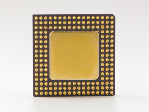 This is a photograph of a processor surrounded by gold connection pins.