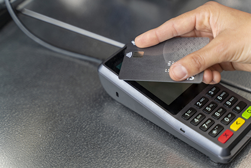 This is a photograph of a contactless debit card being used for payment.