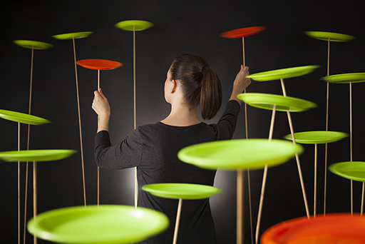 Image of a woman spinning plates.