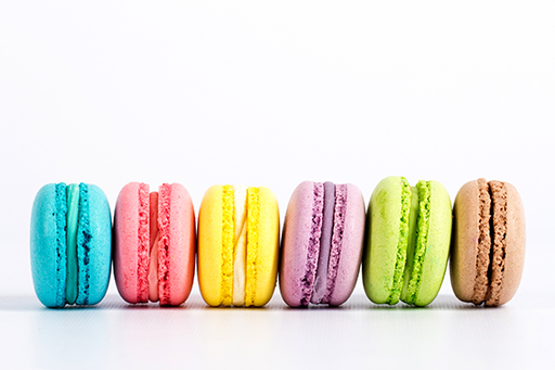 Six coloured macarons lined up.