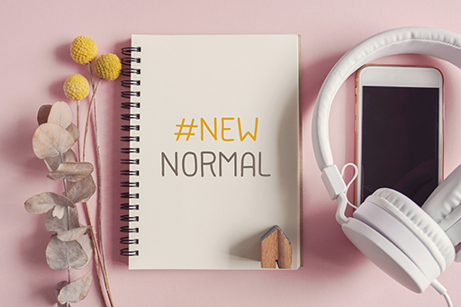 A notepad which on it has written #New normal.