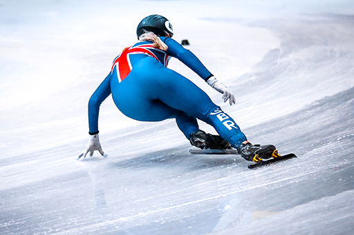 A speed skater racing on the ice.