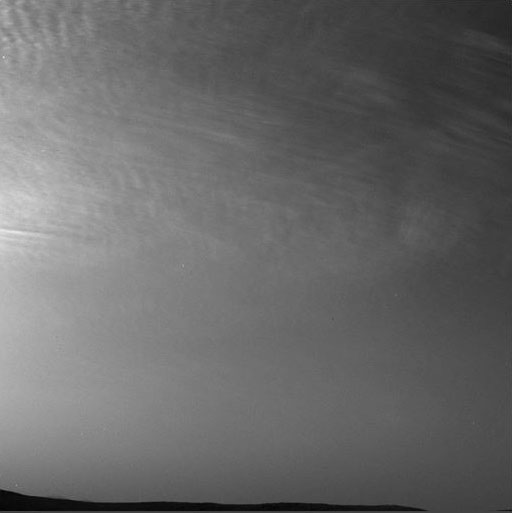 This figure is an animation composed of photographs taken of thin, streaky clouds in the martian atmosphere. The photographs are grey scale. The clouds move from right to left across the images.