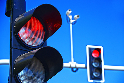 Two red traffic lights – one in the foreground, one in the background.