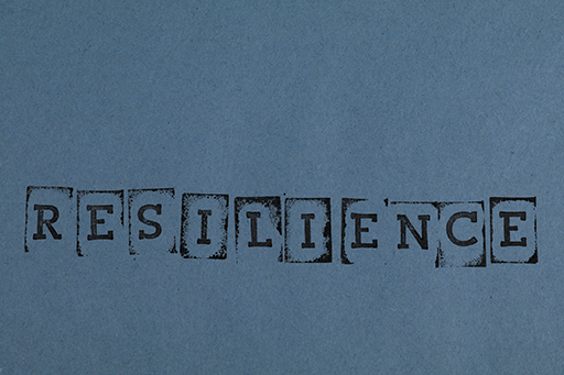 The word ‘Resilience’ printed on blue paper.