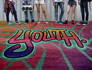 A photograph of the bottom half of six people standing in a line. In front of them is the text: youth.