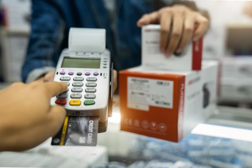 An image of someone using a chip and pin machine to pay.