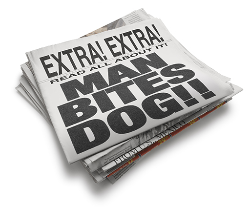 A stack of newspapers with the following written on the front page in bold type: Extra! Extra! Read all about it! MAN BITES DOG!!