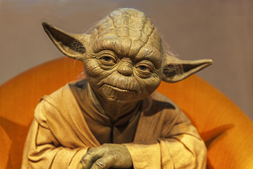 Berlin, Germany, March 2017: Master Yoda wax figure looking thoughtful and wise in Madame Tussaud's museum; Yuri Turkov / Shutterstock.com