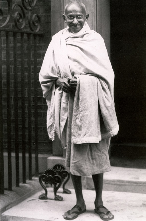 A black-and-white photo of Gandhi.
