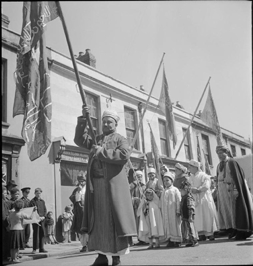 A black-and-white photograph of a procession.