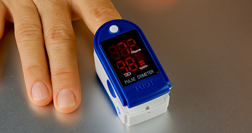A finger in an oximeter to check oxygen levels and pulse.