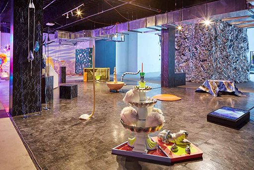 A museum gallery with numerous different installations on the gallery floor.