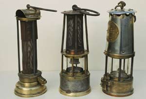 Selection of three old miner lamps in a row