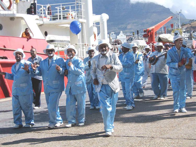 Kaapse Klopse Carnival in Cape Town, South Africa. Behind the diversity of performers is Table Mountain, part of the Cape floristic Region (one of the world’s biodiversity hotspots). [image by Yoseph Araya © copyright Yoseph Araya]