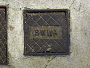 An inspection cover bearing the mark of the old South West Water Authority