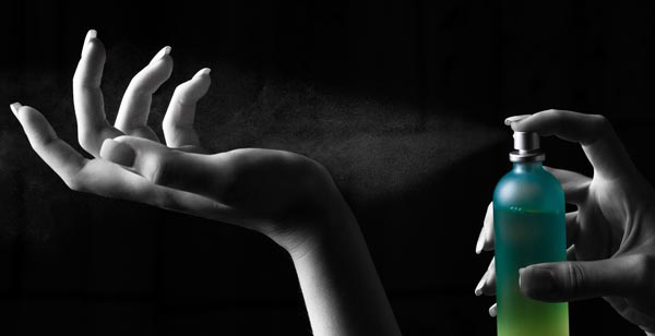 Perfume being sprayed onto a wrist