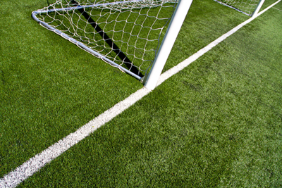 Closeup on the football goal posts and white field lines