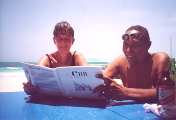 Catherine and Stuart Hall reading The Caribbean Review of Books at Hellshire Beach, Jamaica; June 2004.