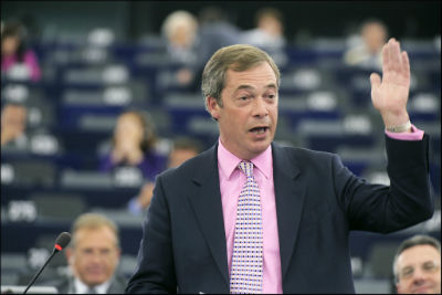 Nigel Farage raises his hand, as if to make a point, during a debate in the European Parliament