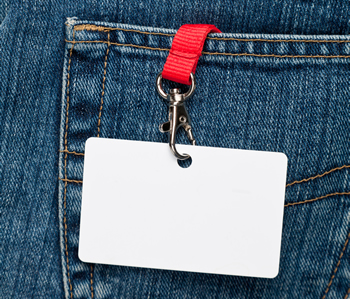  A blank name badge hanging out of a jeans pocket