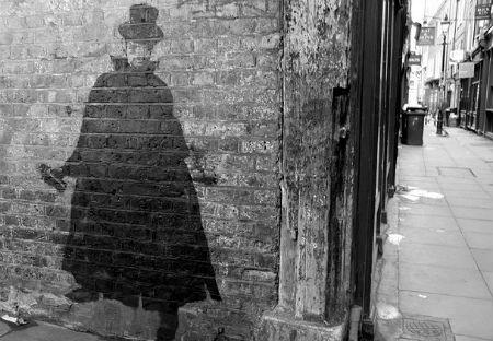 Graffiti depicting the artist's interpretation of  'Jack the Ripper' with a large cloak and hat. 