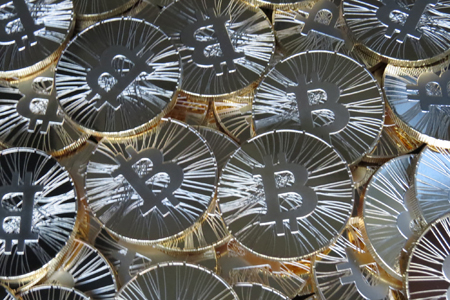 A photo of many physical Bitcoin coins.