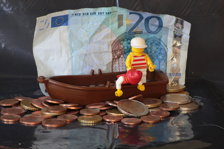 Plastic figures on a boat fishing on a sea of Euro coins.