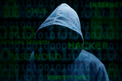 Computer hacker silhouette of hooded man with binary data and network security terms.