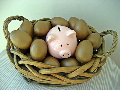 basket of eggs with piggy bank representing baby boom