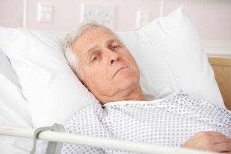 An older patient in a hospital bed