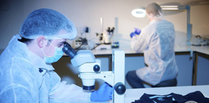 Image of forensic scientists working in a lab. 