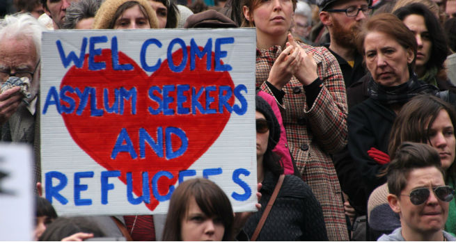 A person holds a welcome sign at the Refugee Action protest, 27 July 2013 Melbourne