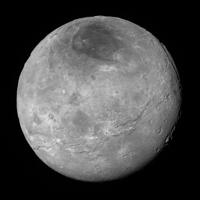The best global view of Pluto’s largest moon Charon (1,200km diameter). The dark north polar cap can be seen at the top.