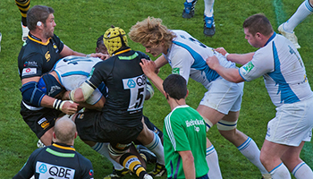 rugby tackle with referee present