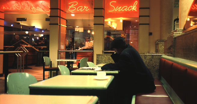 A Man sits alone in a cafe