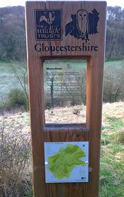Long view of a sign post waymarker for the Laurie Lee poetry walk in Slad valley