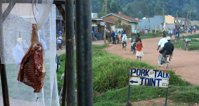 A joint of meat hangs at outside The Pork-Talk Joint in Kabale, Uganda