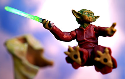 Yoda figurine jumping with a lightsaber