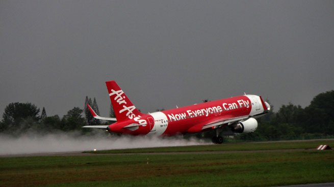 Air Asia plane at takeoff under heavy grey skies