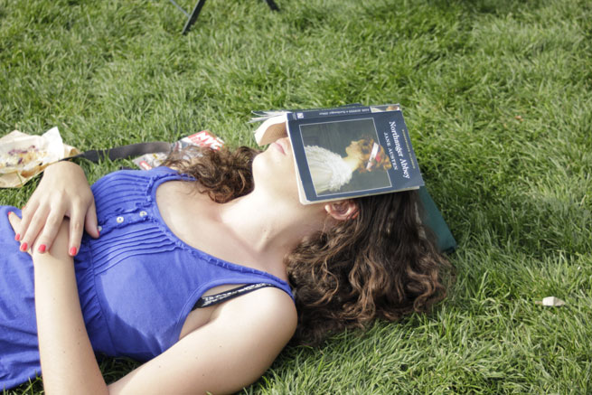 Woman sleeping under a Jane Austen book
