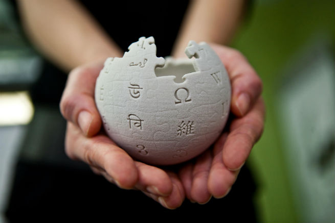 Wikipedia globe held in hands