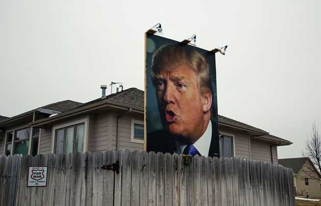 A photograph of 2016 presidential candidate Donald Trump in a residential backyard near Jordan Creek Parkway and Cody Drive in West Des Moines, Iowa, with lights and security cameras.