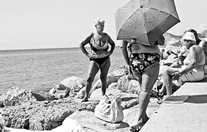 Three older women at a beach in black and white