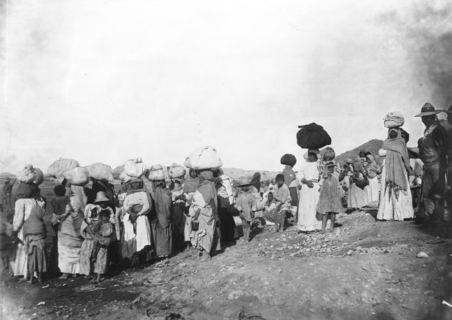 A group of more than 30 Yaqui Indian prisoners being escorted away by Mexican soldiers, Mexico, ca.1910