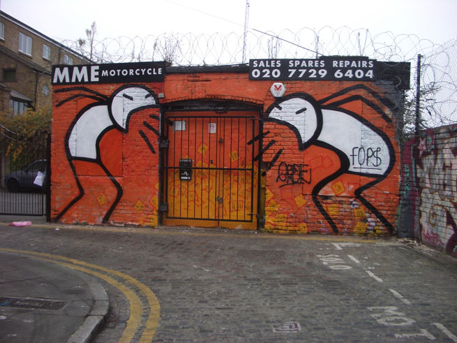 Painted stick men on the side of a building, apparently vomiting