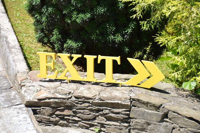 The word Exit sits on a wall, waiting to be used in all manner of metaphorical contexts