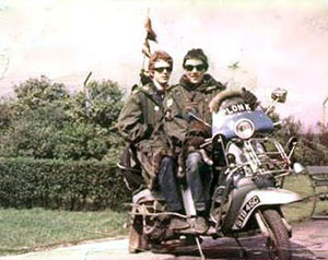 A photograph of two early-1960s mods on a customised scooter