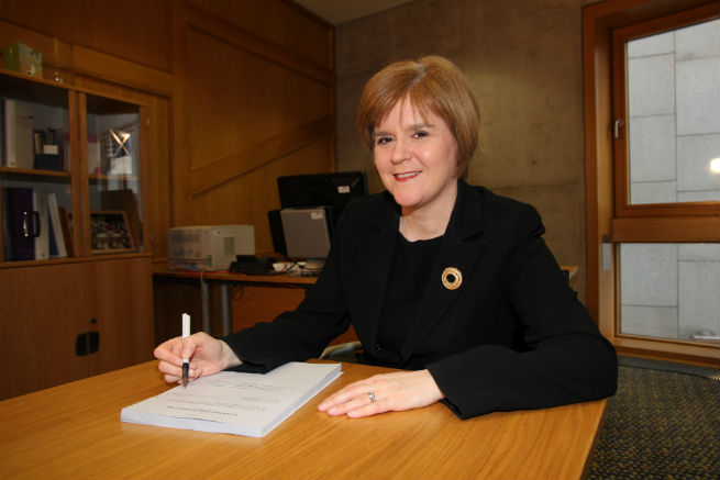 Nicola Sturgeon signing the original Scottish Independence Referendum Bill